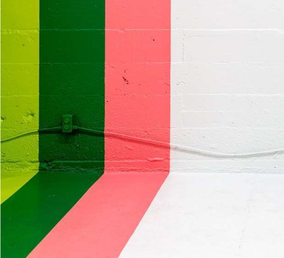 painted stripes running from the floor to the wall, green, darker green, pink and white